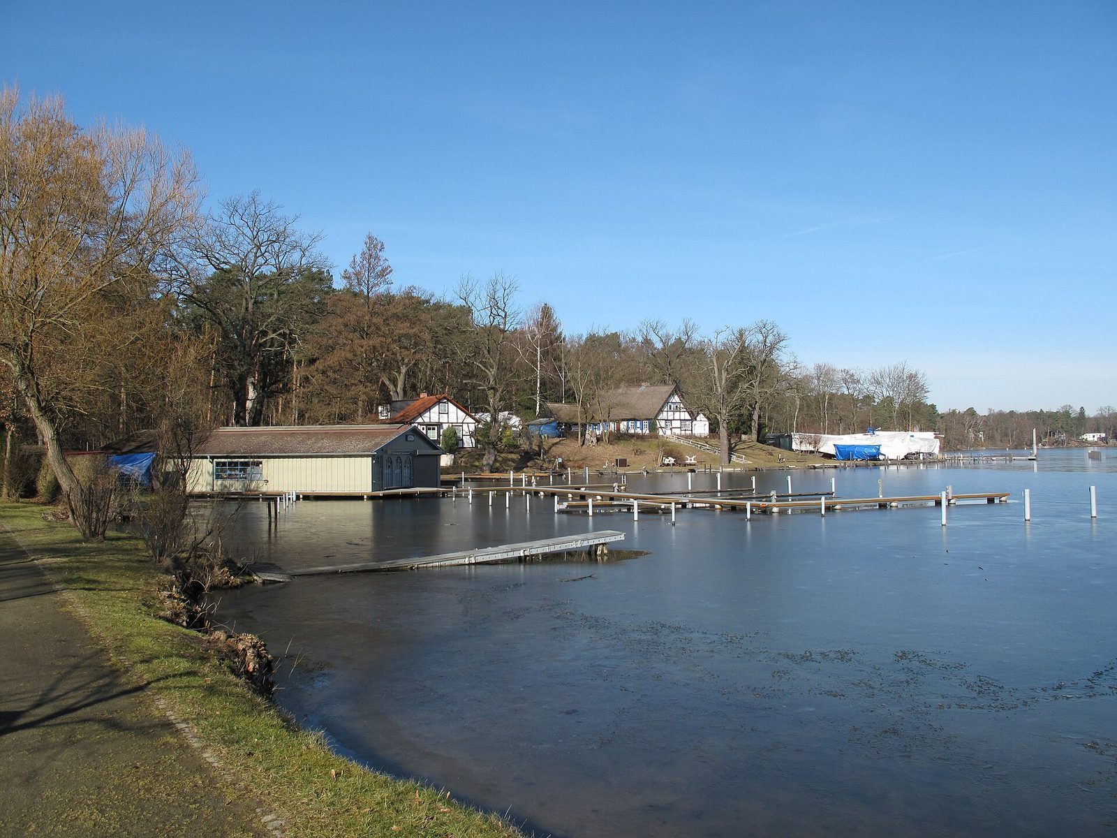 Bad Saarows bryggeanlegg ved Scharmützelsee, med et båthus og brygger ut i det stille vannet