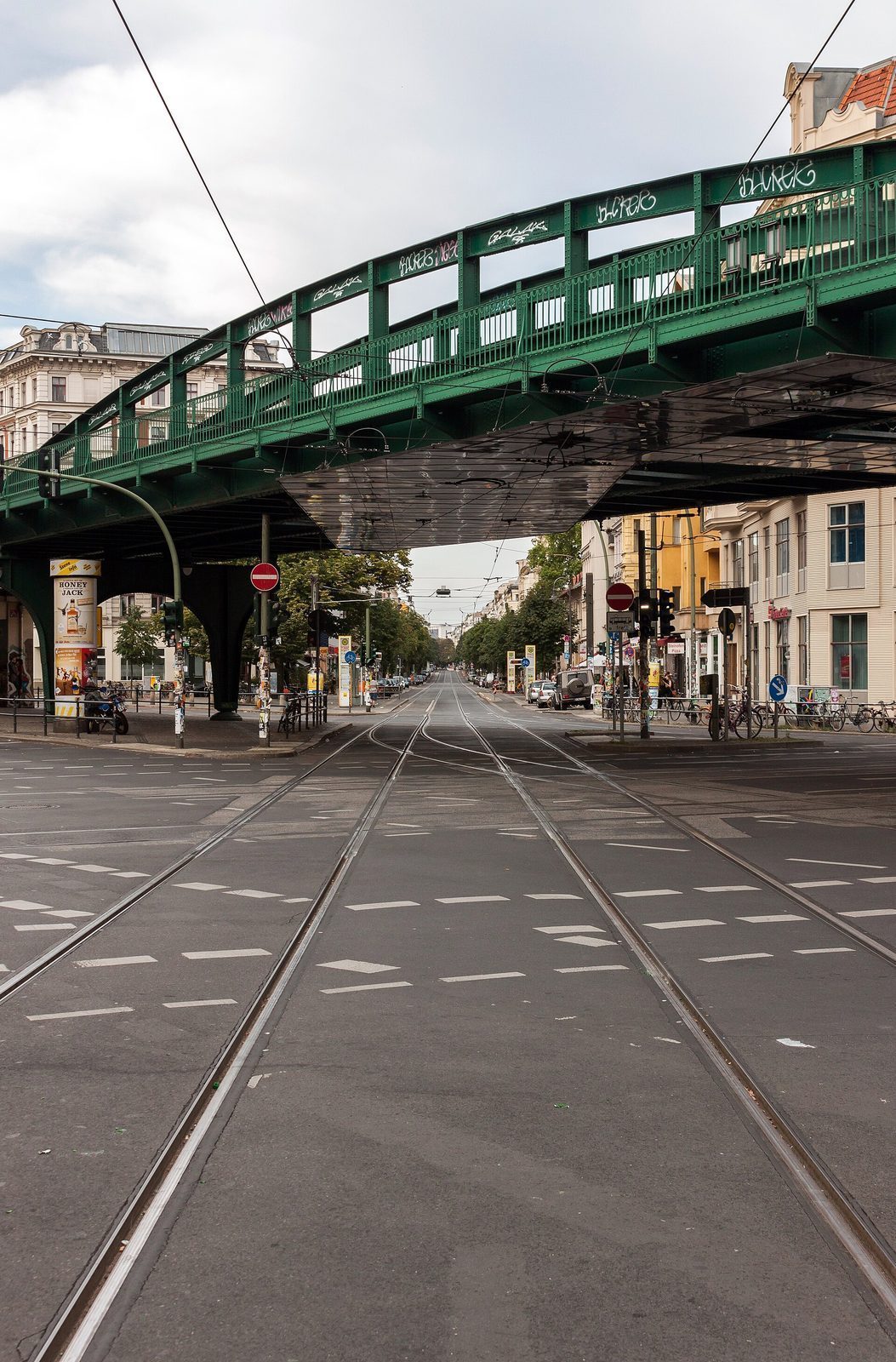 Den grønne U-Bahn-viadukten over trikkeskinnene i en trelagt gate i Prenzlauer Berg