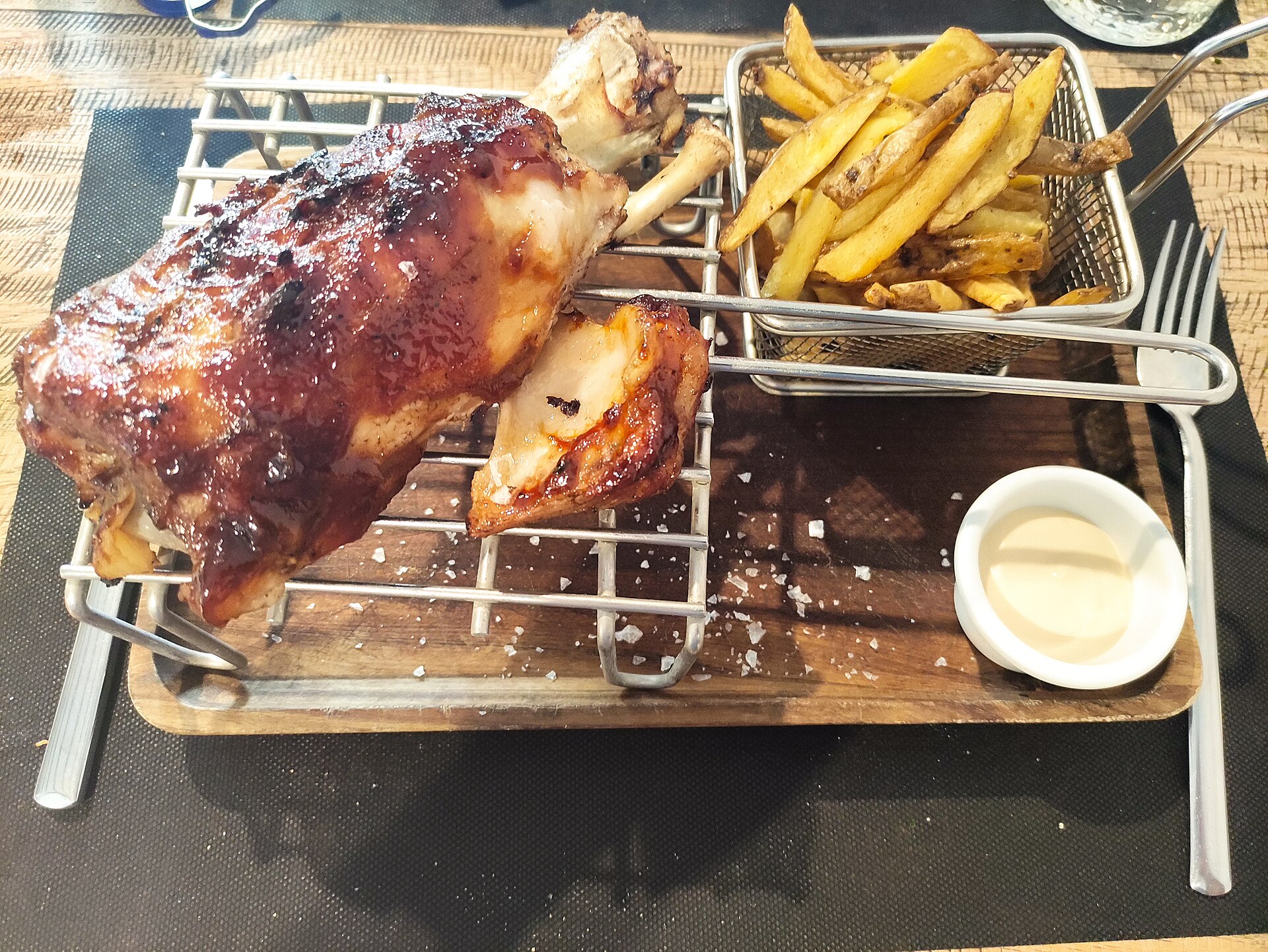 Grillet svinekjøtt servert med pommes frites i en kurv